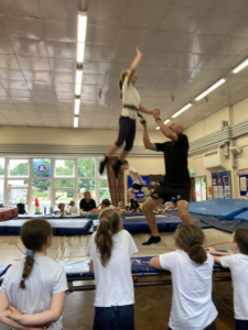 child on trampoline trusting teacher to help her