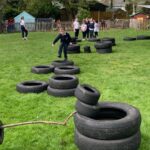 pupils playing on old tyres