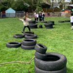 pupils playing on old tyres